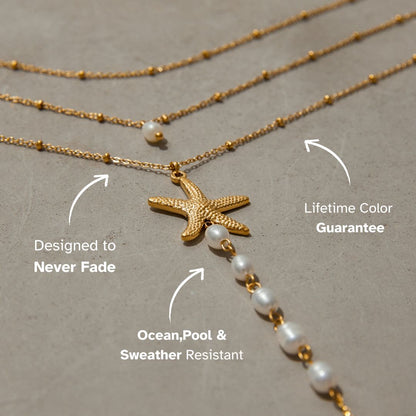 Zoomed view of pearl chain dropping from starfish charm against skin