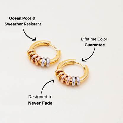 Gold hoop earrings with silver, rose gold, and gold rings