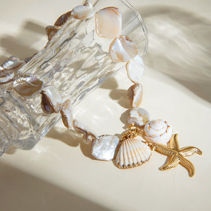 Flat lay of gold and shell statement jewelry in sunlight