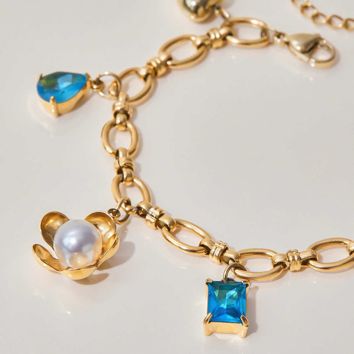 Layered gold bracelets on woman’s wrist with natural light reflections