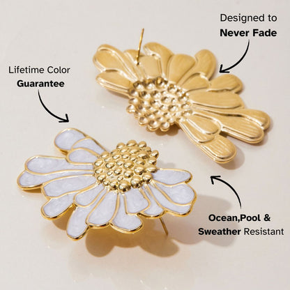 Side view of gold and white floral earrings with shiny petal texture