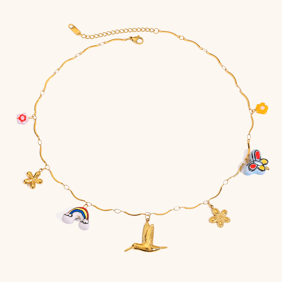 Gold necklace with rainbow, bird, clover and butterfly pendants in a colorful enamel finish