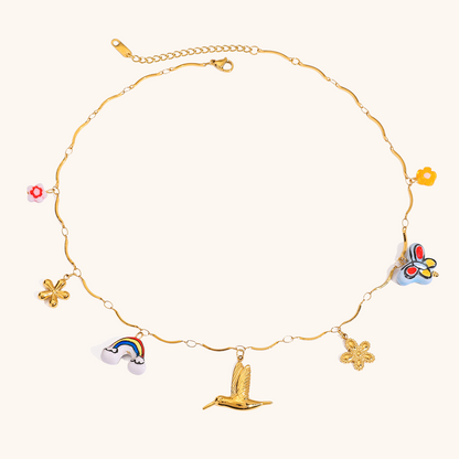 Gold necklace with rainbow, bird, clover and butterfly pendants in a colorful enamel finish