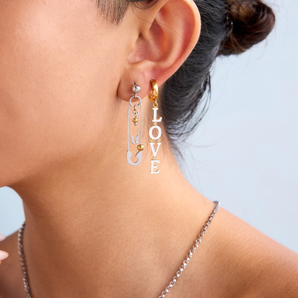 Romantic gold and white enamel earrings shaped in the word “LOVE”_MiFJewelry
