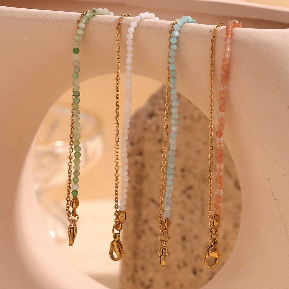 Spring tone bracelet set featuring pastel white and mint green gemstones on warm-toned props.