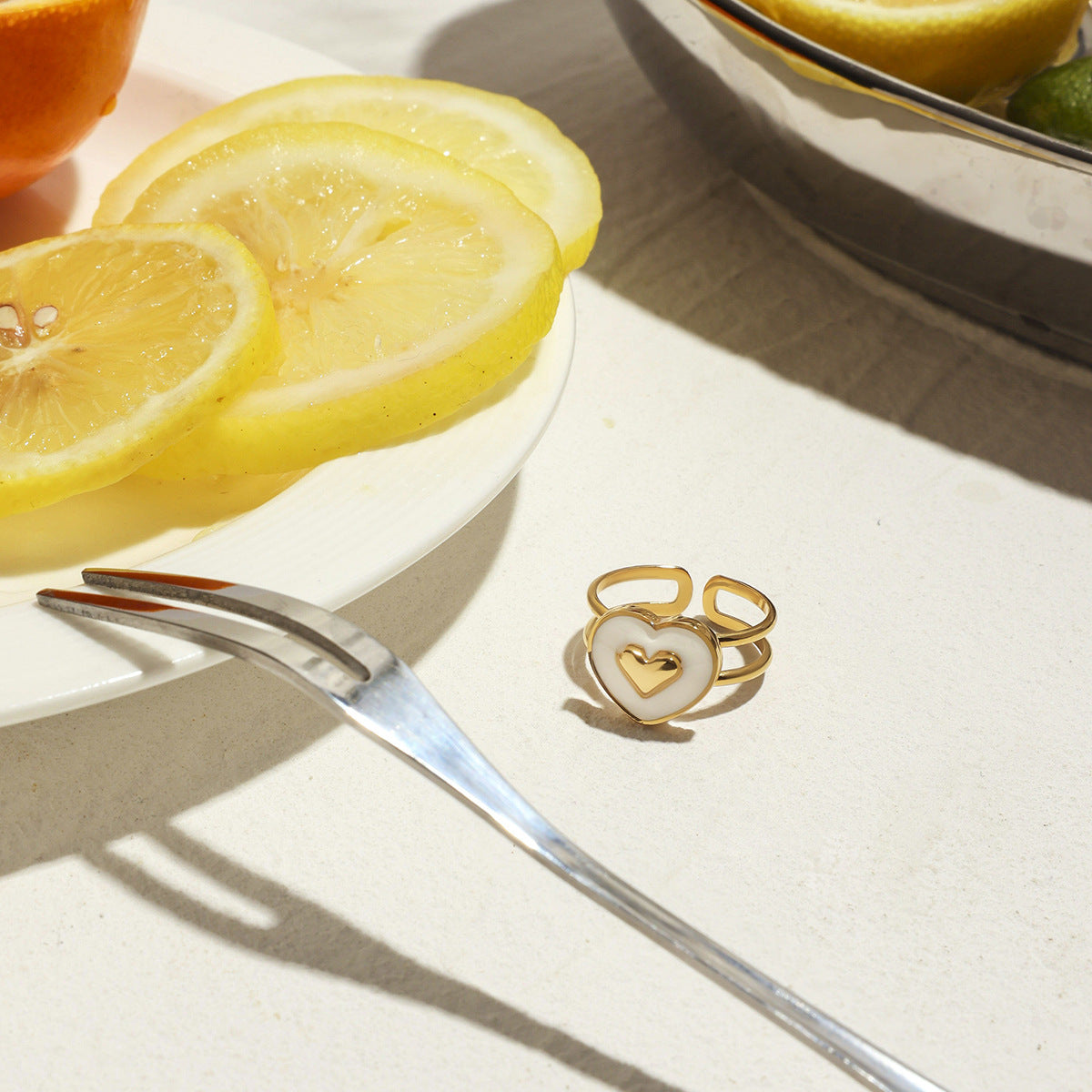 Romantic heart ring on lemon table setting, summer accessory flatlay