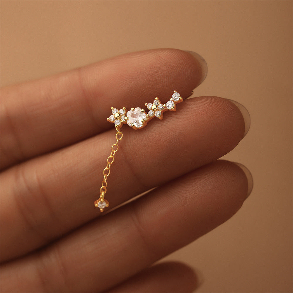 Studio image of gold plated zircon chain earrings, minimal and delicate celestial design.