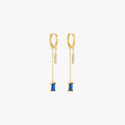 Gold drop earrings with blue gemstones, luxurious and trendy.