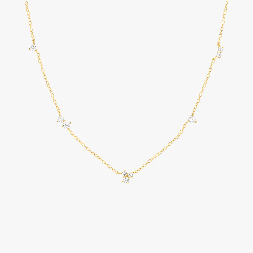 Gold necklace with delicate star-shaped charms, perfect for layering