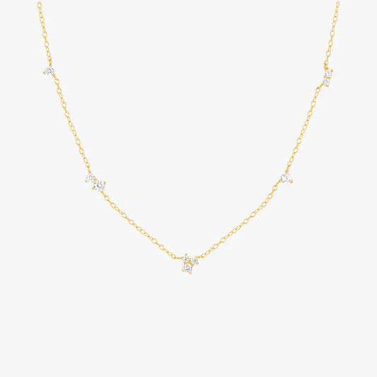 Gold necklace with delicate star-shaped charms, perfect for layering