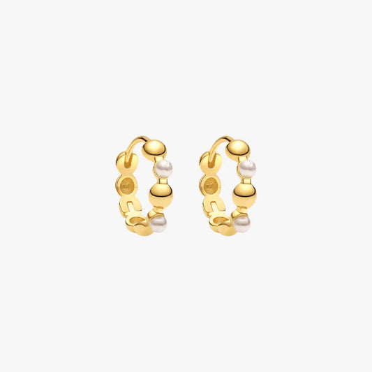 Geometric gold hoop earrings with pearls, blending modern design with classic elements.