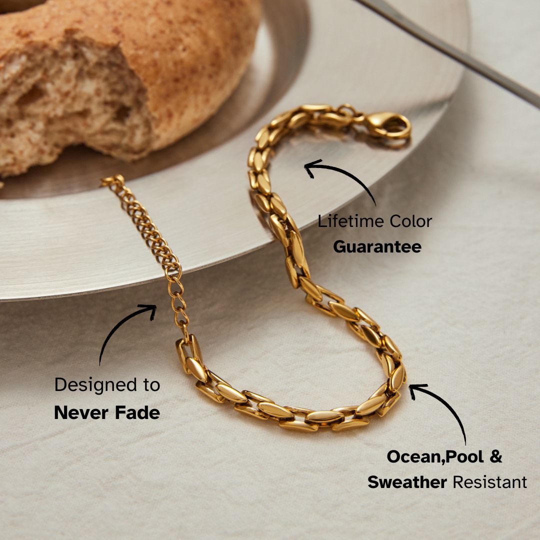 Elegant waterproof gold chain bracelet with clasp, styled on a silver plate for modern lifestyle