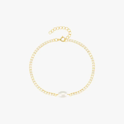 Luxury gold bracelet with a minimalist design featuring a central pearl.