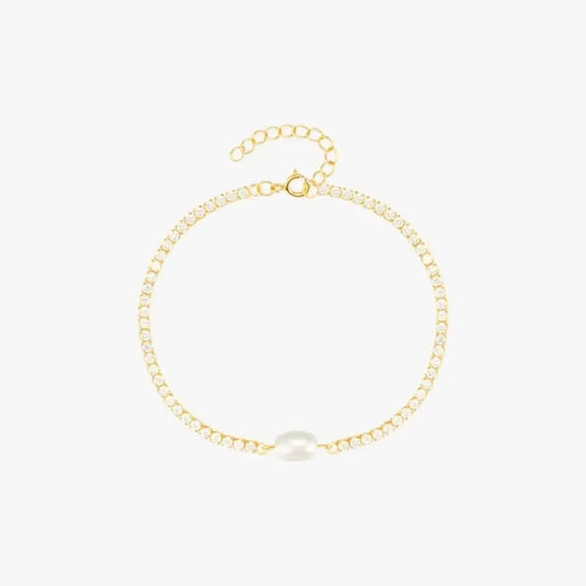 Luxury gold bracelet with a minimalist design featuring a central pearl.