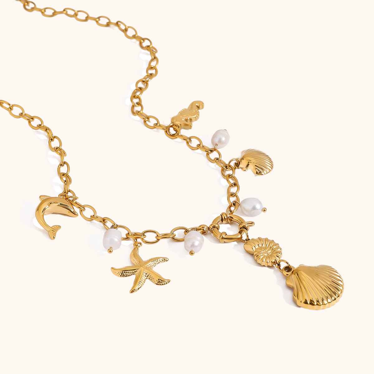 Detail of beach-inspired necklace featuring dolphin, seahorse, starfish, and shell charms