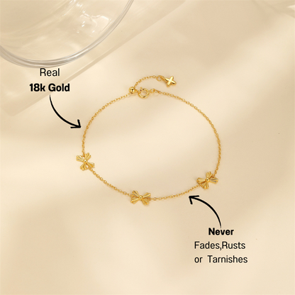 Minimalist butterfly charm bracelet in gold-plated sterling silver, perfect for everyday elegance.