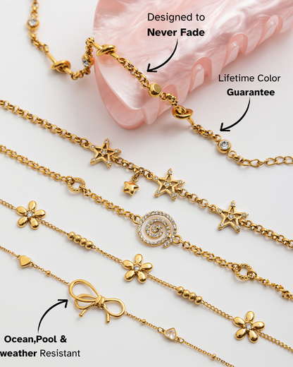 Gold bracelets with various charms on a light background
