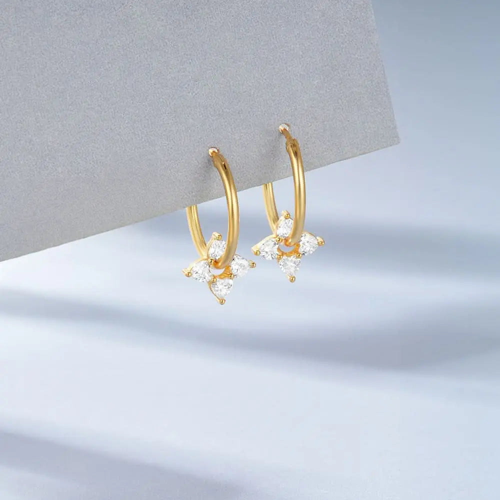 Minimalist gold diamond stud earrings on model, ideal for an elegant and refined look.