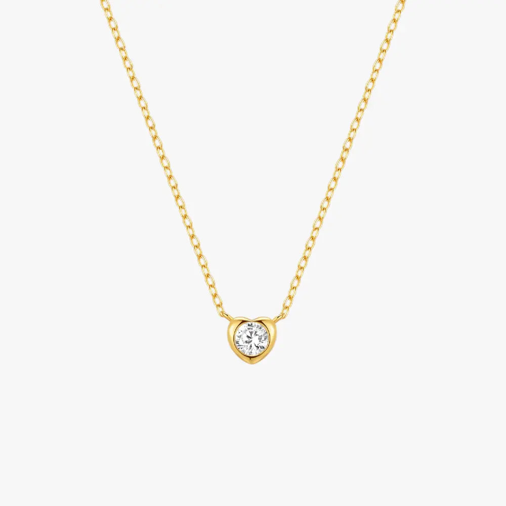 Minimalist gold heart-shaped pendant necklace with a zircon center